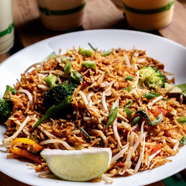 Nokturne World Kitchen's healthy fried rice with broccoli, bean sprouts, and a lime wedge.