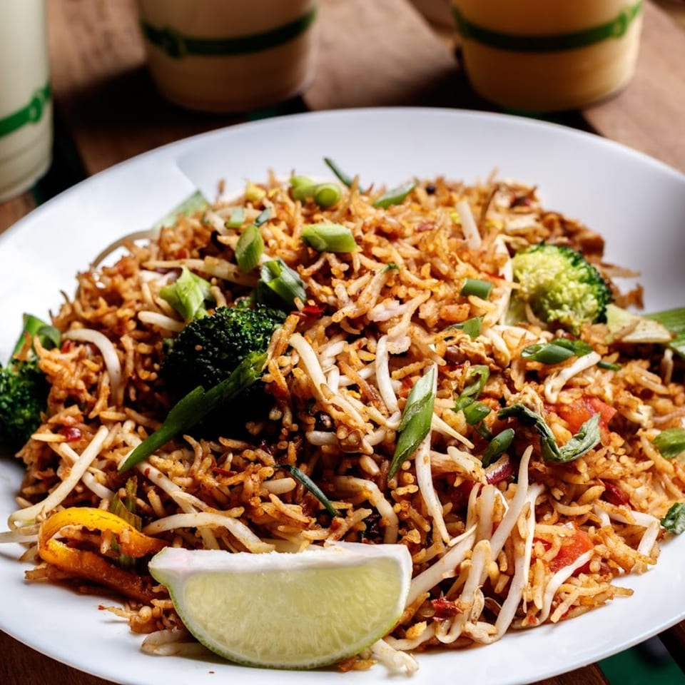Nokturne World Kitchen's healthy fried rice with broccoli, bean sprouts, and a lime wedge.